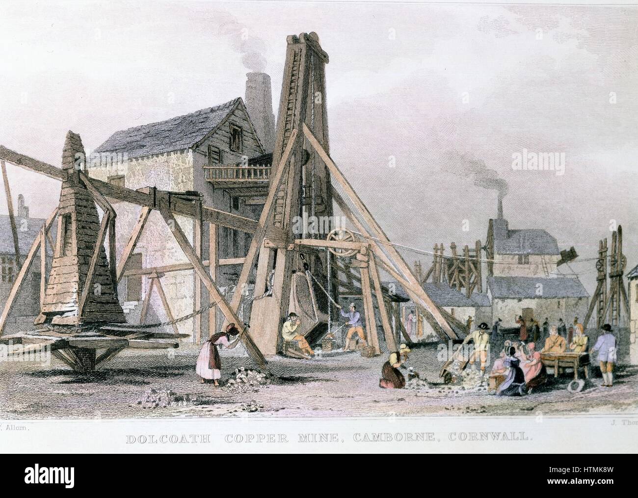 Dalcoath copper mine, Cambourne, Cornwall (later also tin), showing engine houses and 'Bolling Maidens' who broke ore into small pieces. Engraving c1830 Stock Photo