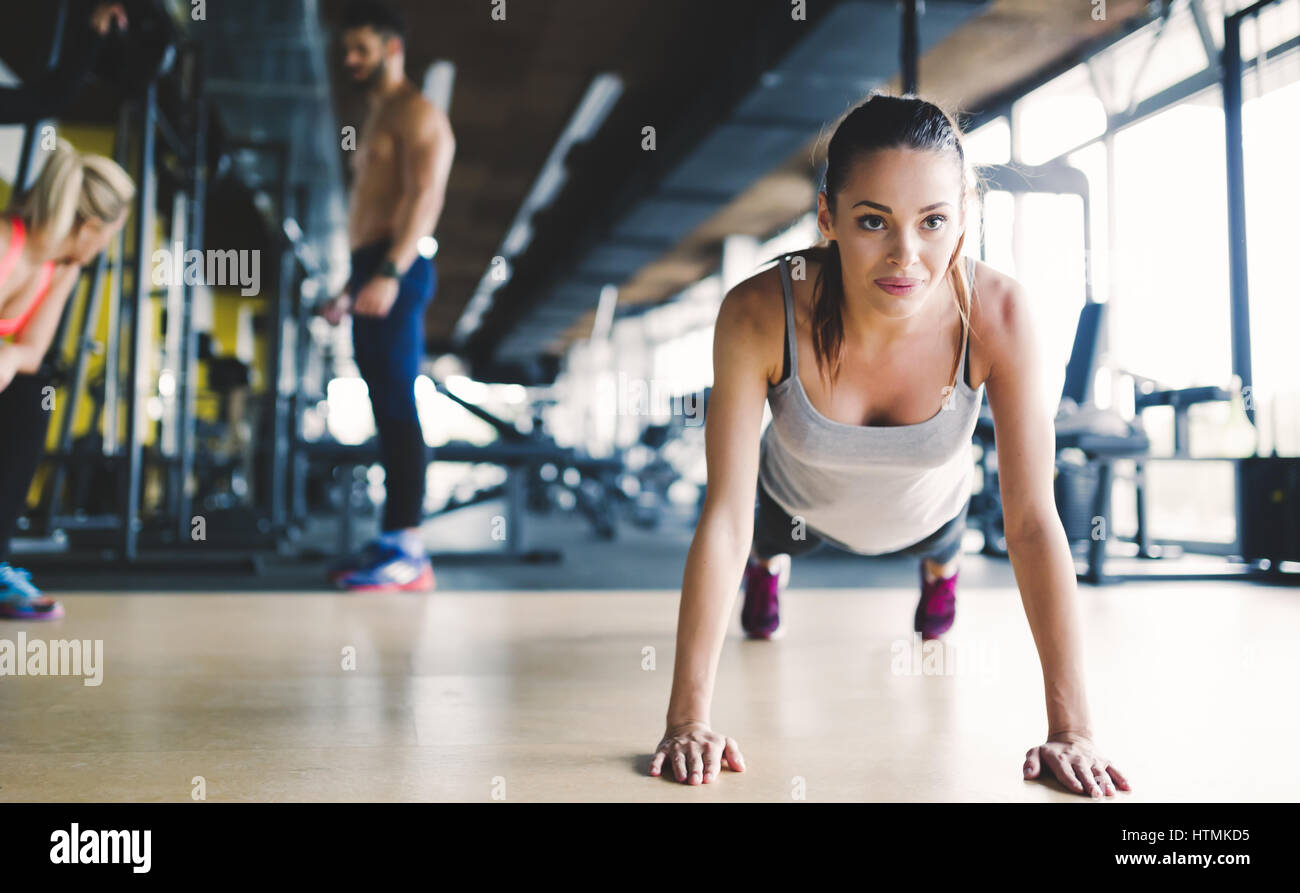 Healthy focused girl doing push ups in gym Stock Photo - Alamy