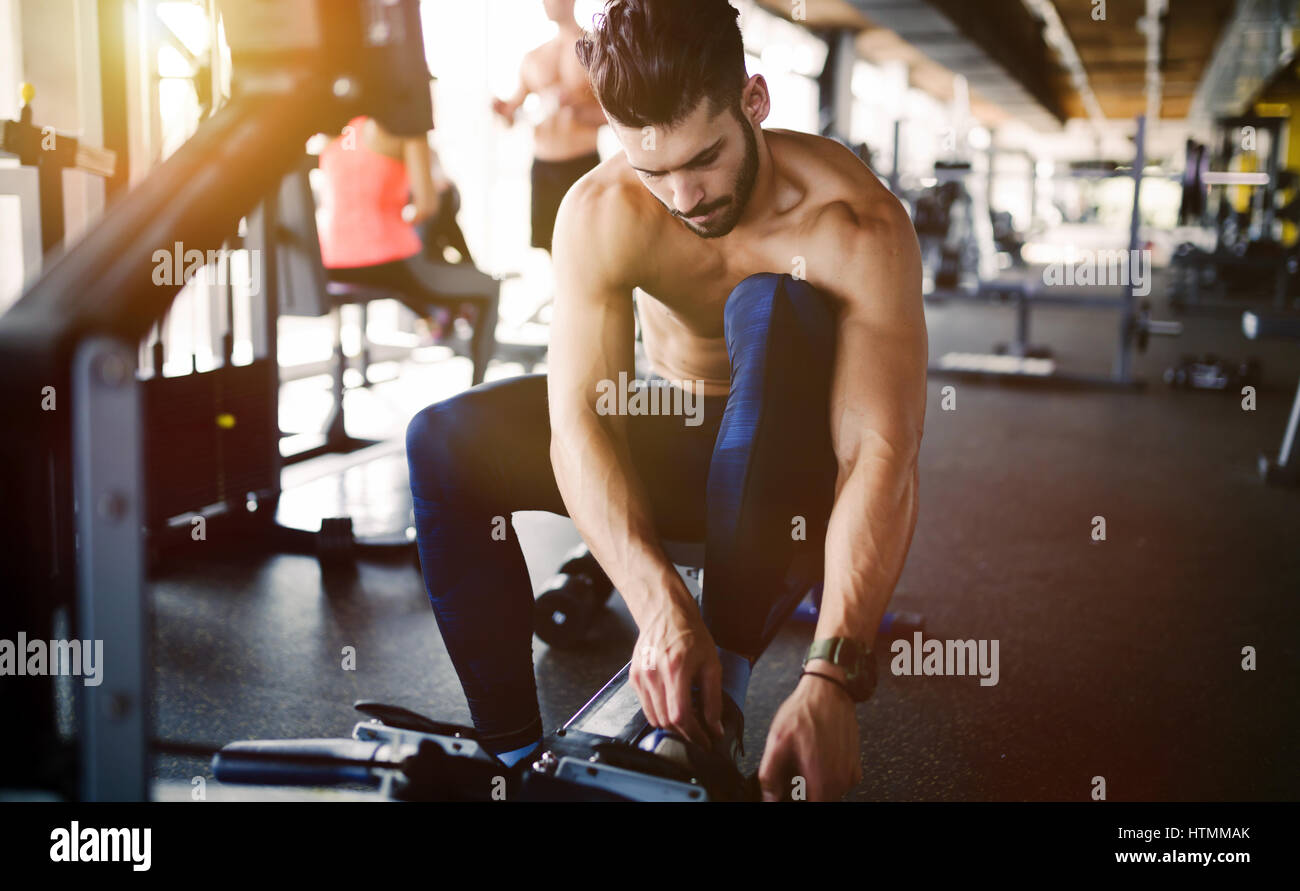 Determined body builder working out in gym Stock Photo