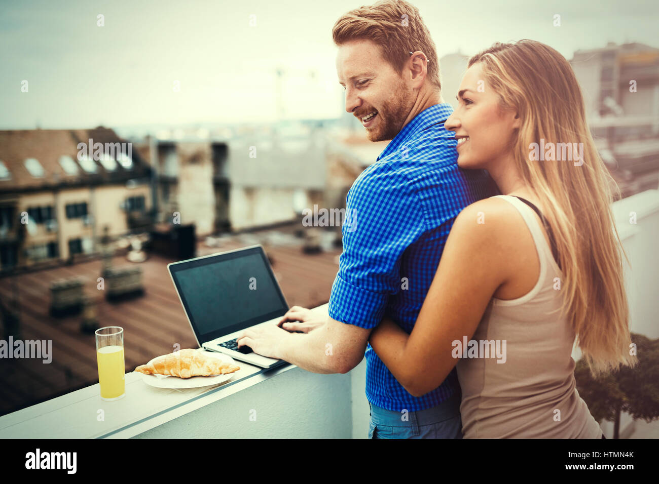 Couple in love hugging outdoors in top of building Stock Photo - Alamy