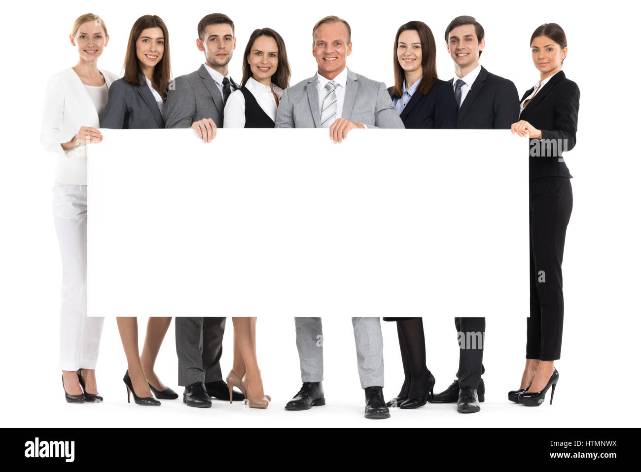 Full length portrait of business team holding blank billboard isolated on white background Stock Photo