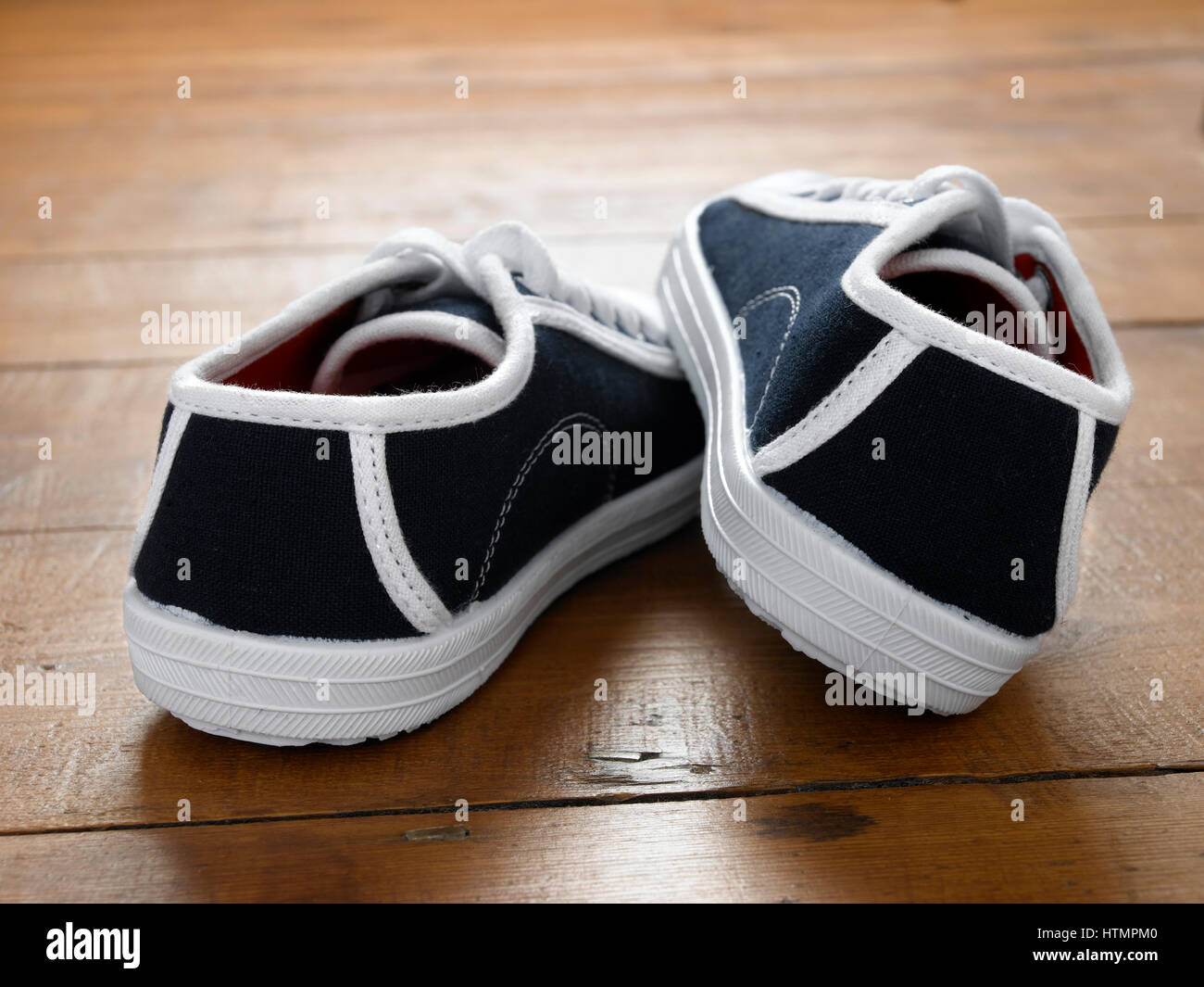 Pair of sneakers on wooden floor Stock Photo - Alamy