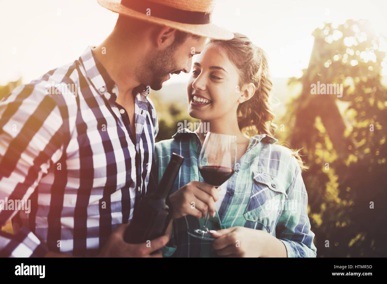 Happy people tasting wine in vineyard Stock Photo - Alamy