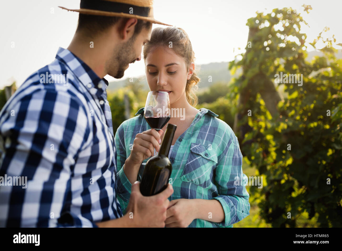 Happy people tasting wine in vineyard Stock Photo - Alamy