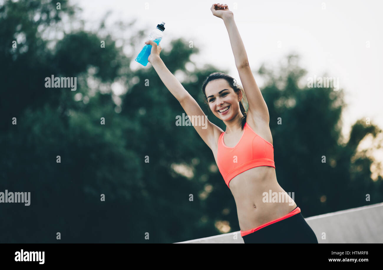 Beautiful female jogger happy after achievment in sports Stock Photo