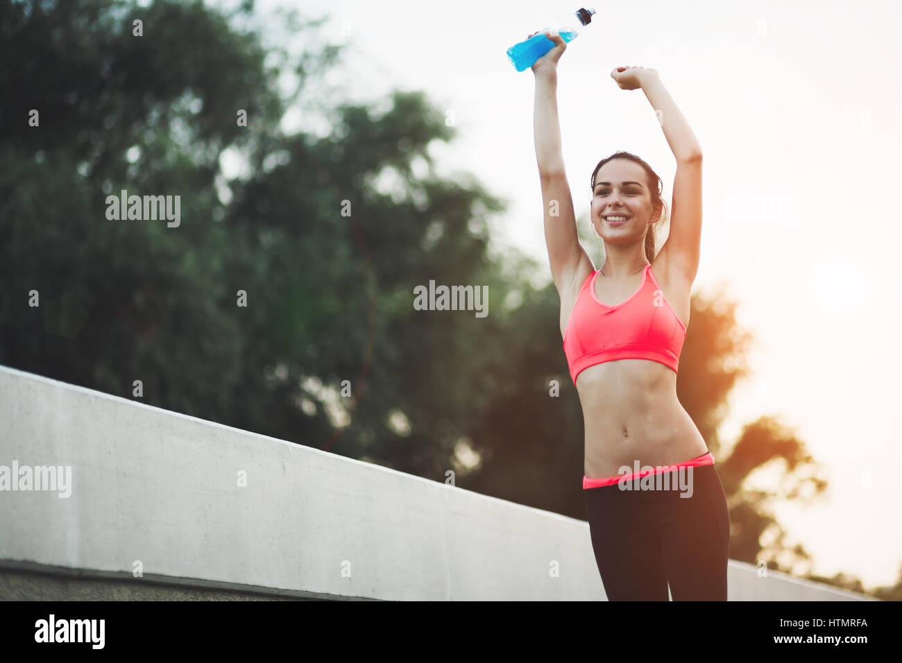 Beautiful female jogger happy after achievment in sports Stock Photo