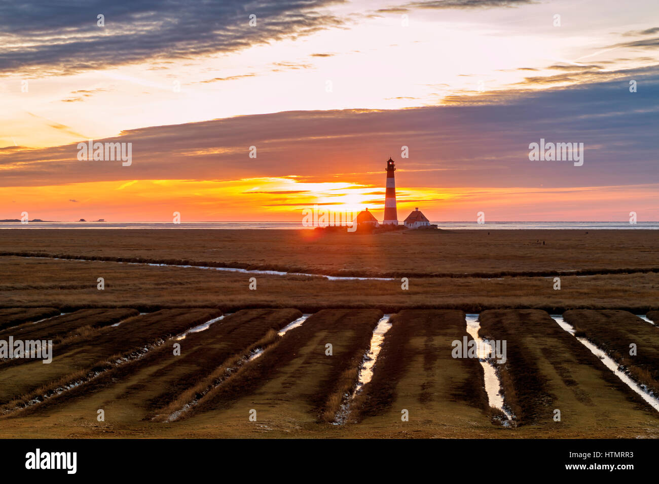 Sunset at the lighthouse Westerheversand, North Frisia, Germany Stock Photo