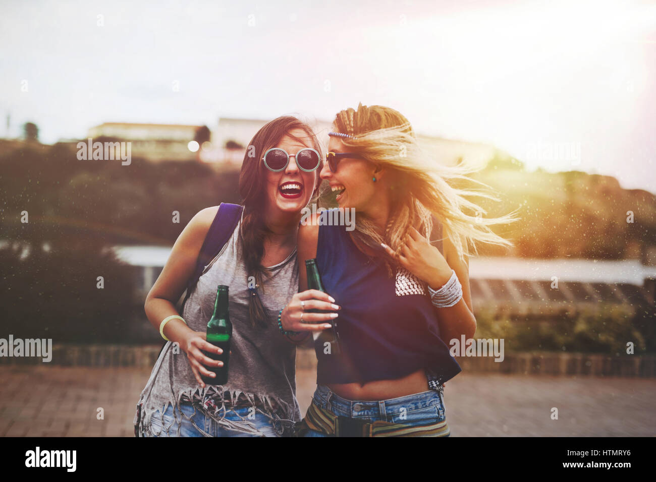 Festival party girls in summer having fun and drinking Stock Photo