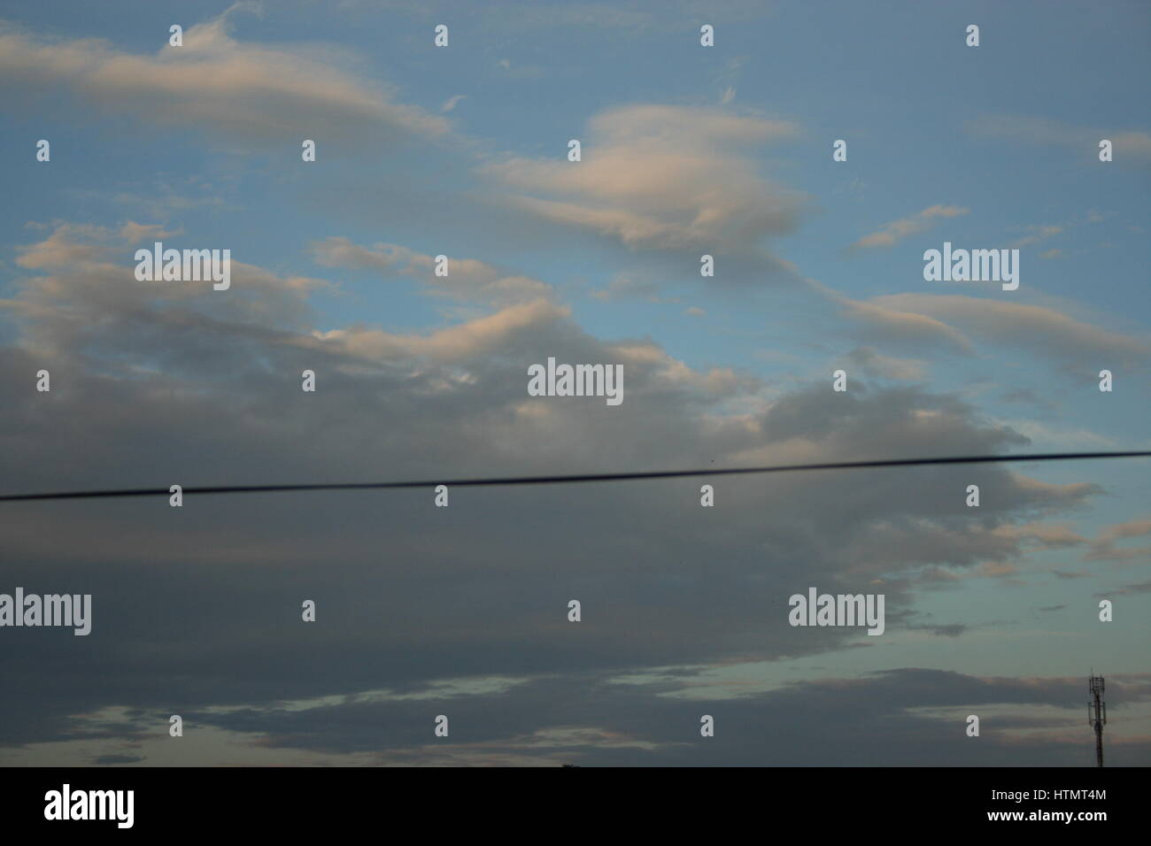 Electrical power line with cloud over blue sky Stock Photo - Alamy