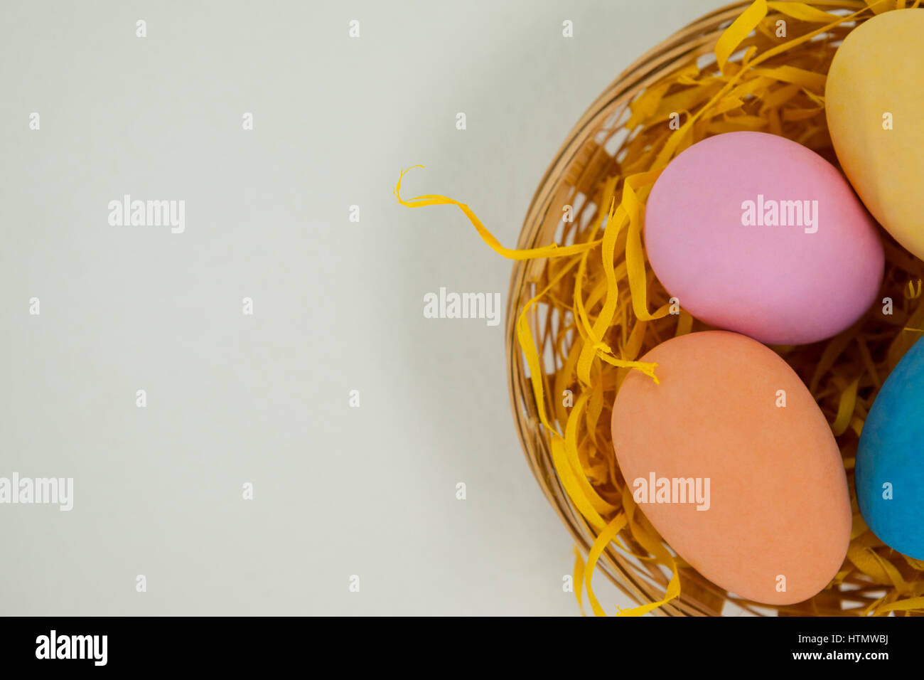 Painted easter eggs in basket against white background Stock Photo - Alamy