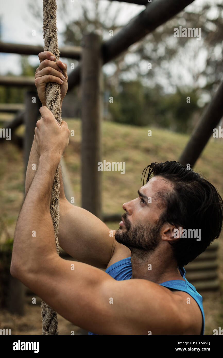 Man climbing rope during obstacle hi-res stock photography and images ...
