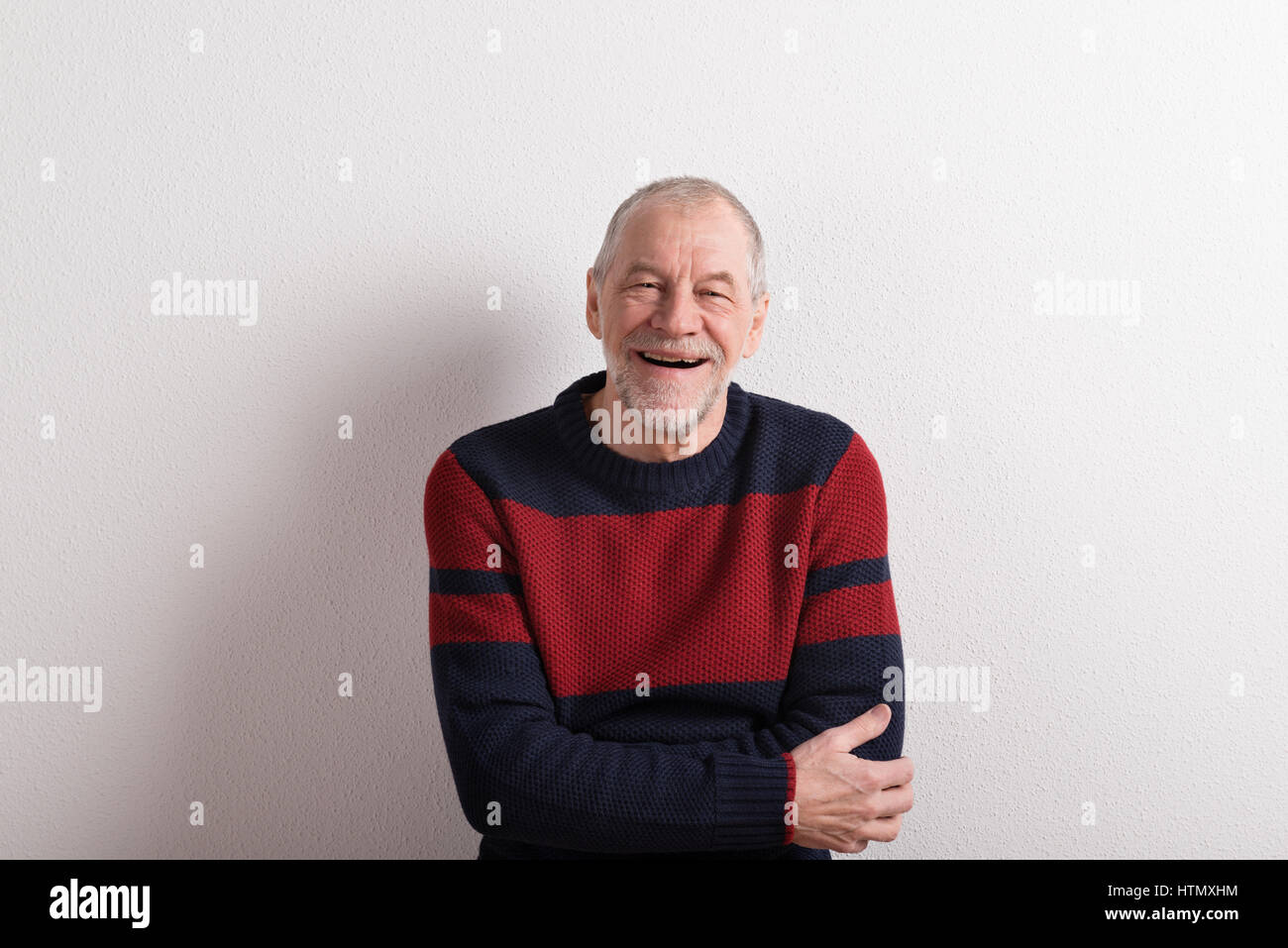 Senior man in red sweater hi-res stock photography and images - Alamy