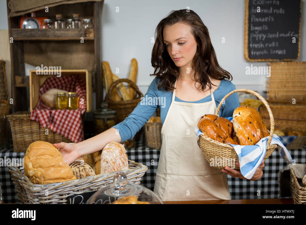Female staff working at bakery counter in market Stock Photo Alamy