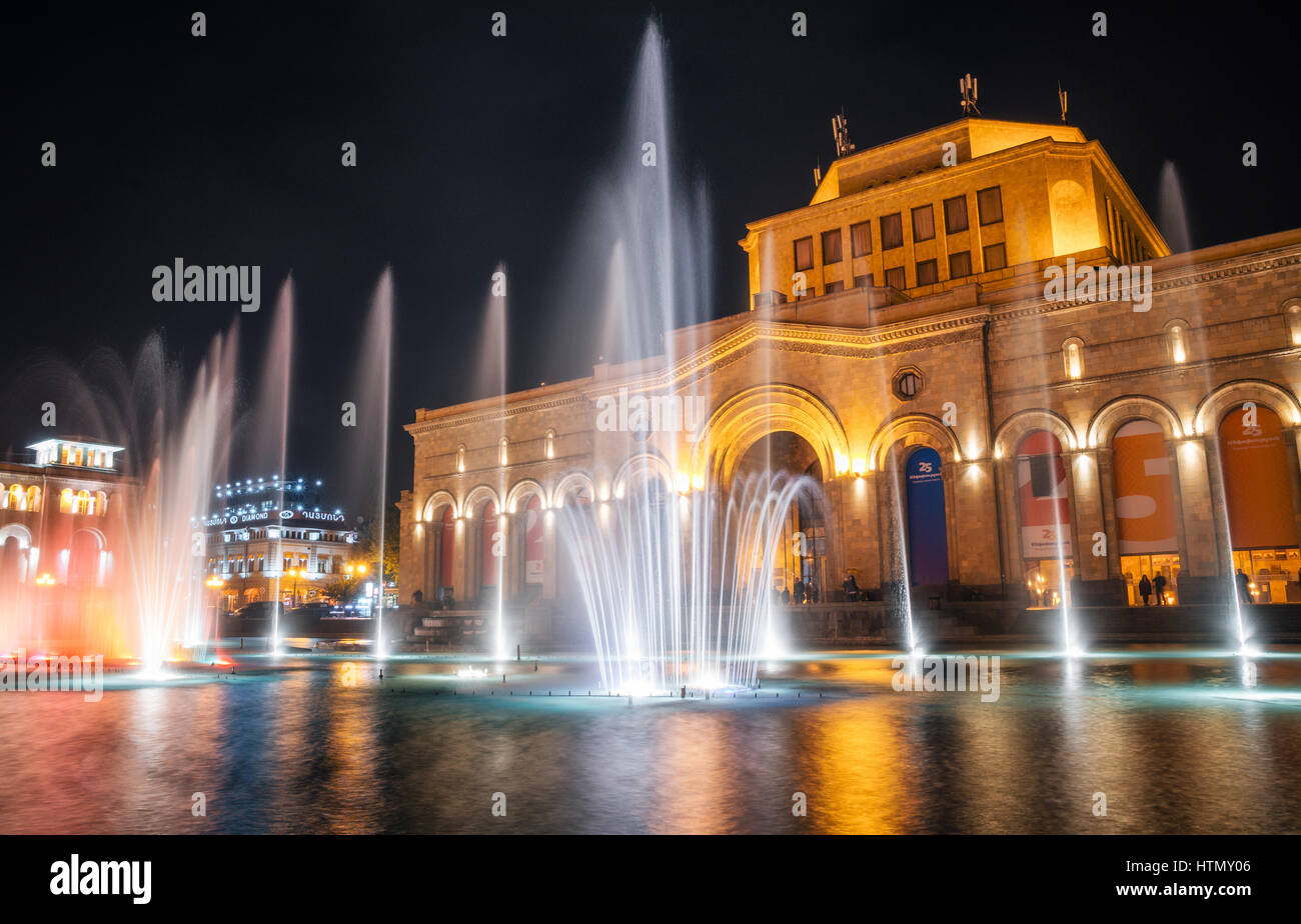 The colored singing musical dancing fountains against the building of the National Gallery and History Museum of Armenia Stock Photo