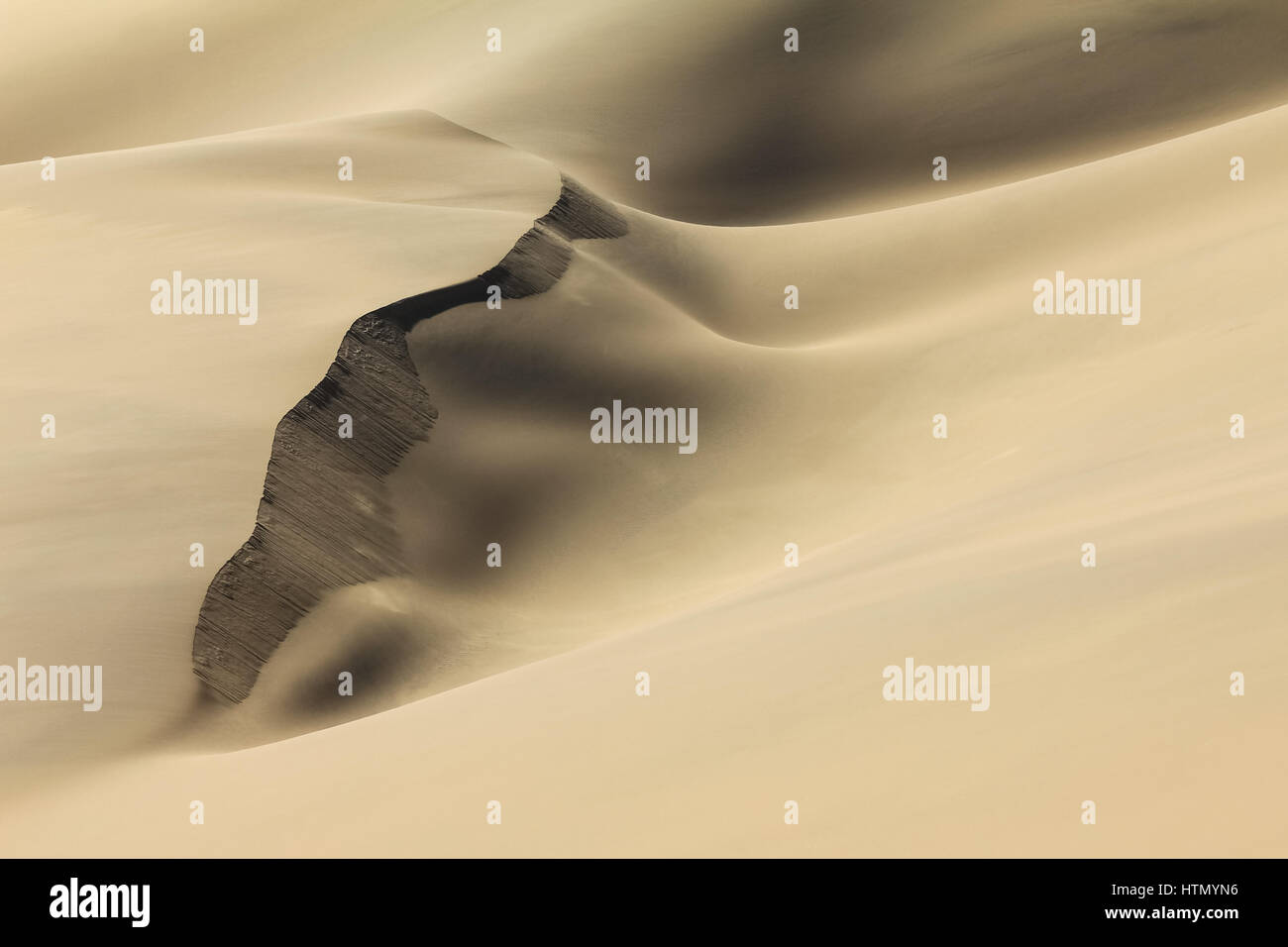 Shifting sand dune contrasts. Desert or beach sand textured background. Stock Photo