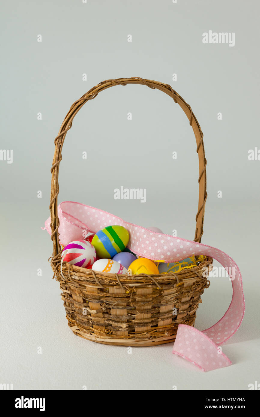 Various Easter eggs in wicker basket on white background Stock Photo ...