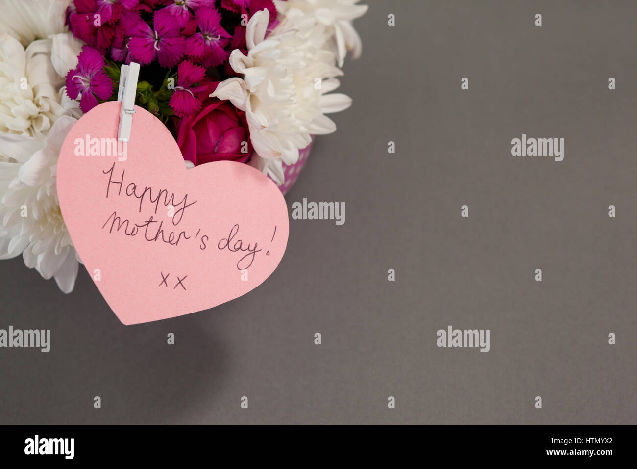 Bunch of fresh flowers with happy mothers day card on grey background ...