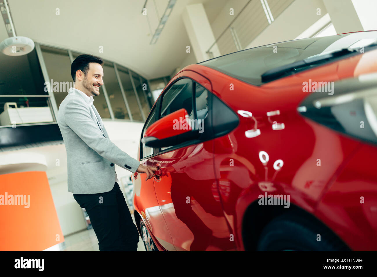 Handsome customer buying car at dealership Stock Photo Alamy
