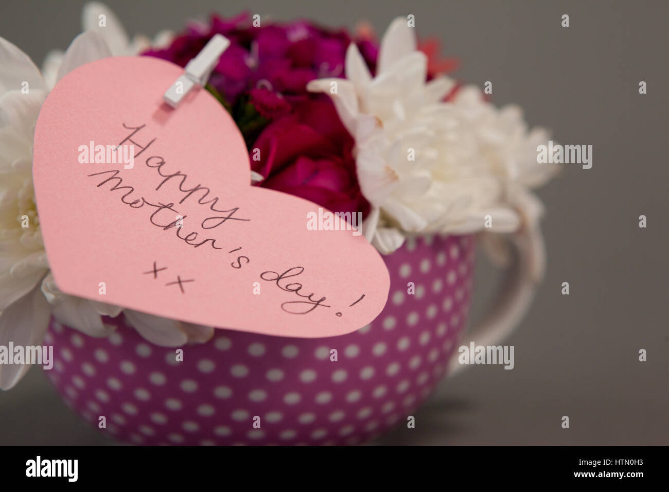 Bunch of fresh flowers with happy mothers day card on grey background ...