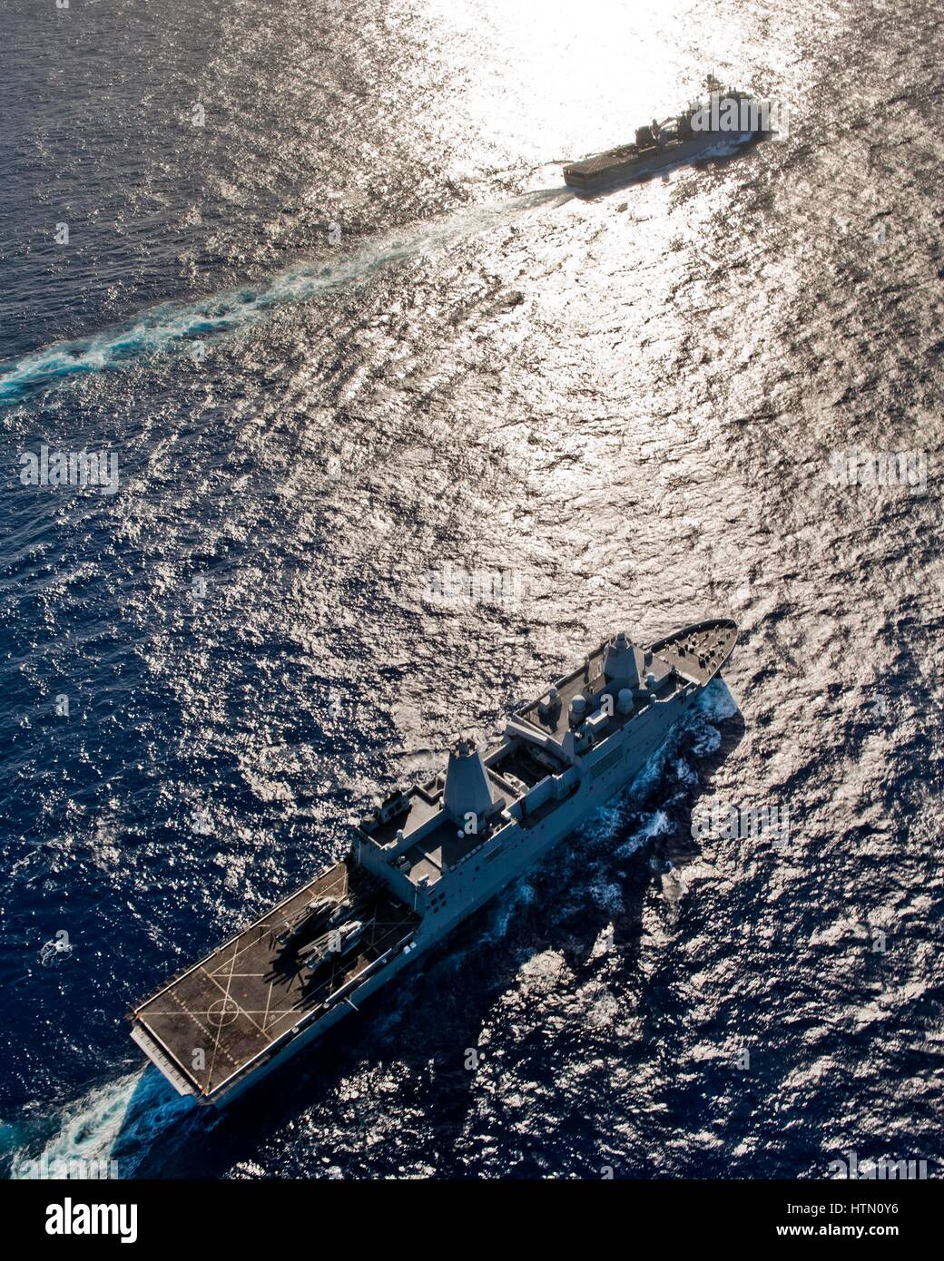 The USN San Antonio-class amphibious transport dock ship USS New York (front) and the USN Whidbey Island-class amphibious dock landing ship USS Gunston Hall steam in formation December 10, 2012 in the Atlantic Ocean. Stock Photo