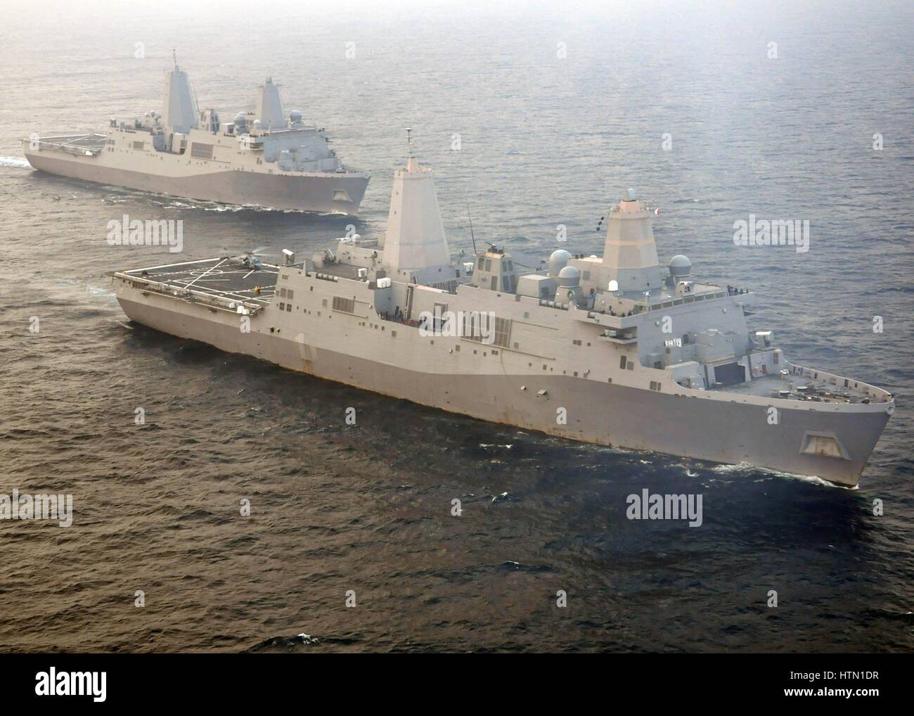 The USN San Antonio-class amphibious transport dock ships USS New York (back) and USS San Antonio steam in formation June 9, 2011 in the Atlantic Ocean. Stock Photo