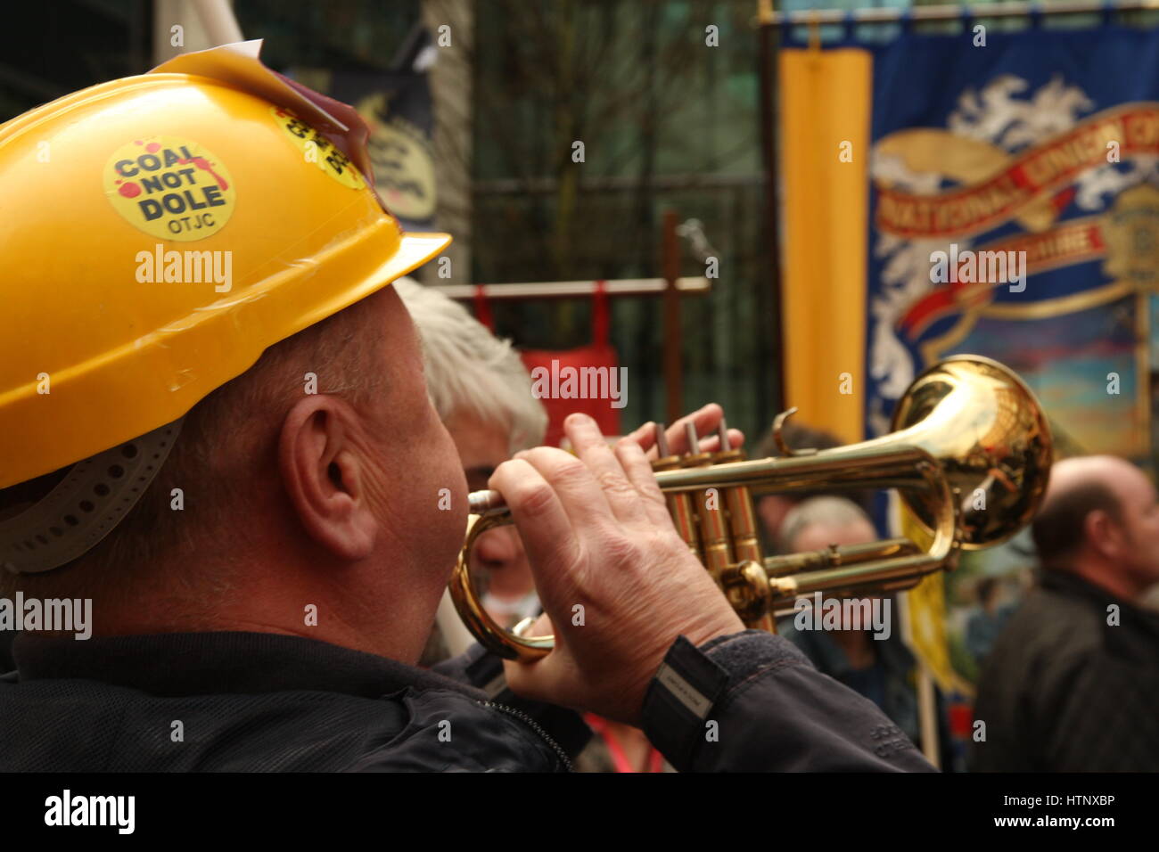 Westminster, London, UK 13th March 2017.A man in a miner's hat blows a trumpet as protesters from the Orgreave Truth and Justice Campaign hold a noisy protest outside the Home Office building. The campaign is demanding an inquiry into events during the Miner's Strike when police attacked miners picketing the Orgreave coking plant. Roland Ravenhill/Alamy Live News Stock Photo