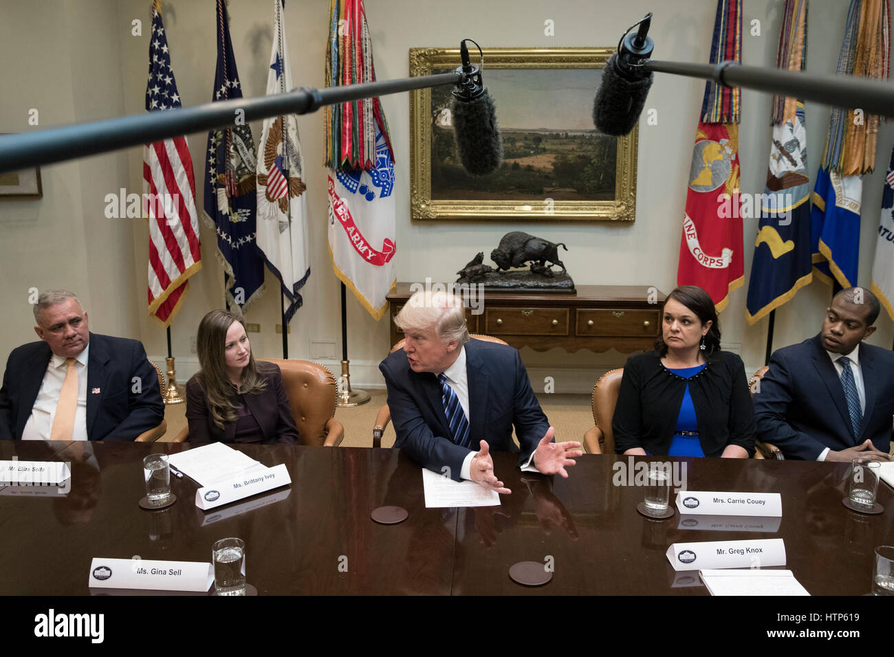 US President Donald J. Trump (C) attends a meeting on healthcare in the Roosevelt Room of the White House in Washington, DC, USA, 13 March 2017. The House Republicans' bill known as the 'American Health Care Act', which is intended to replace the Affordable Care Act and endorsed by President Trump, has faced criticism from both Republicans and Democrats. Also in this picture is Kim Elias Seife (L) of Florida, Brittany Ivey (2-L) of Georgia, Carrie Couey (2-R) of Colorado and Louis Brown (R) of Virginia. Credit: Michael Reynolds/Pool via CNP · NO WIRE SERVICE · Photo: Michael Reynolds/C Stock Photo