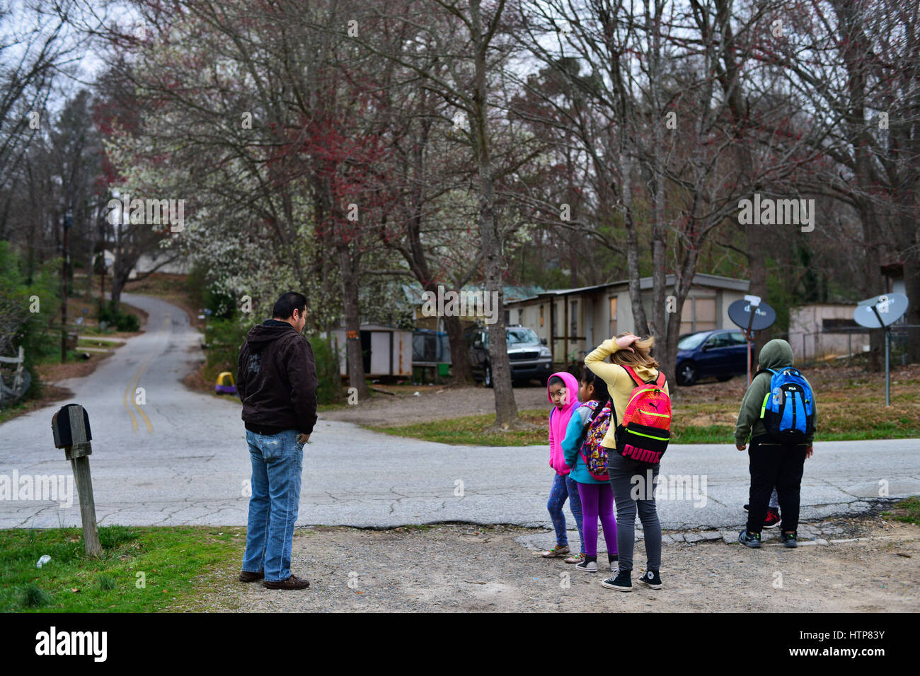 February 28, 2017 - Enrique, an undocumented immigrant from Mexico, waits for the bus to take his daughter Abigail, a 6-year-old American citizen, to school in the Gainesville public school district, which is now 58 percent Latino, a percentage growing every year. The most recently-built elementary school is almost entirely Latino. Credit: Miguel Juarez Lugo/ZUMA Wire/Alamy Live News Stock Photo
