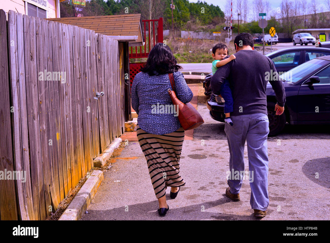 Gainesville, Georgia, USA. 1st Mar, 2017. Enrique, an undocumented immigrant from Mexico, his wife Angelica and their 1-year old son Enrique Jr.--an American citizen--head into the office of a notary to certify documents that would give custody of their three children to a nephew in the event they are deported from their home in Gainesville, Georgia, where police checkpoints have become more common during the new Trump administration. Credit: Miguel Juarez Lugo/ZUMA Wire/Alamy Live News Stock Photo