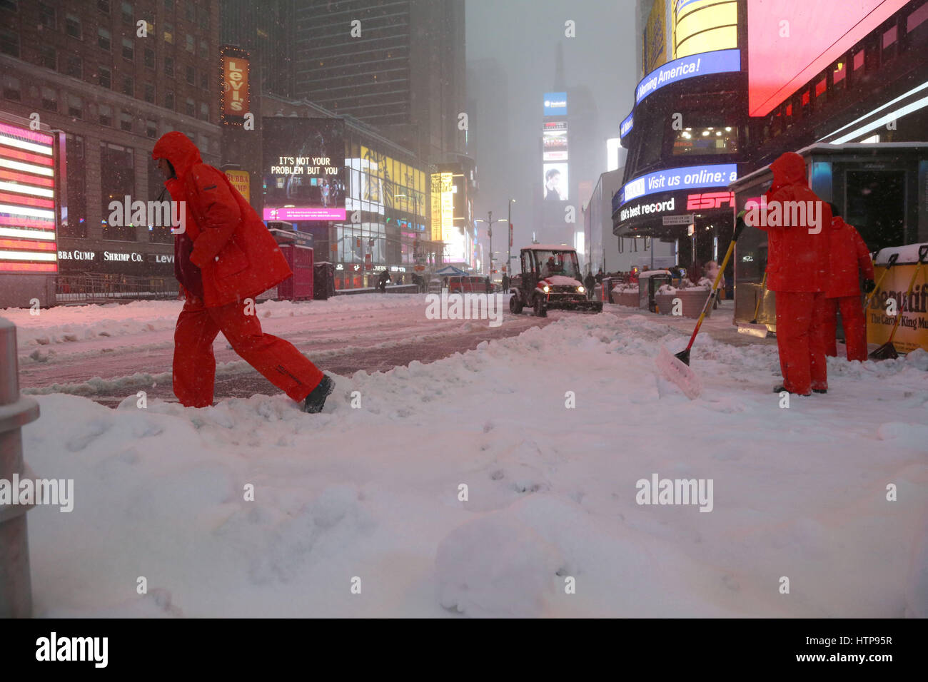 Times Square Alliance workers shovel snow in Times Square during Winter Storm Stella in Times Square. Stock Photo