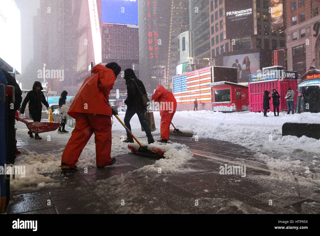 Times Square Alliance workers shovel snow in Times Square during Winter Storm Stella in Times Square. Stock Photo