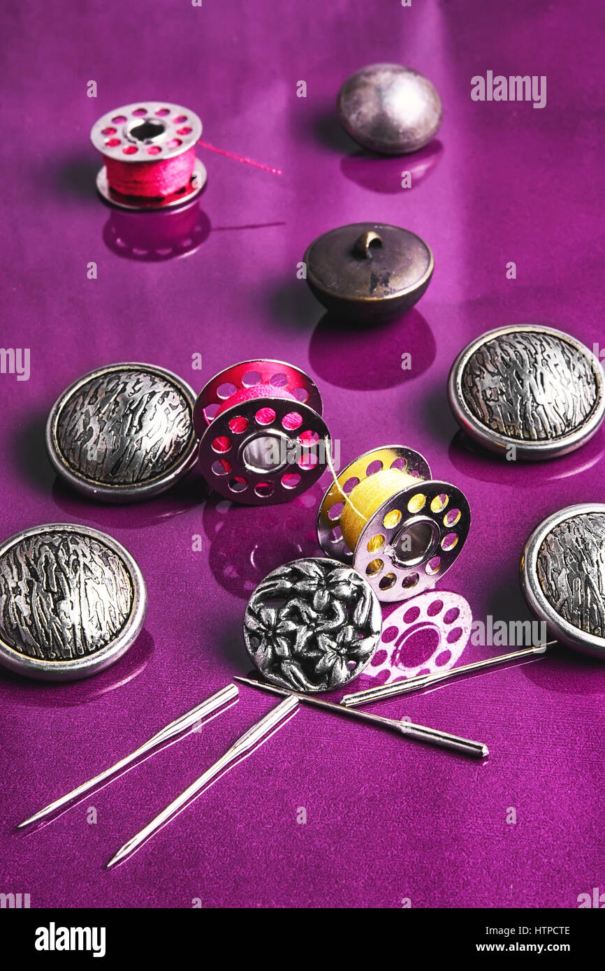 Set of beautiful buttons,sewing needle and bobbin Stock Photo - Alamy