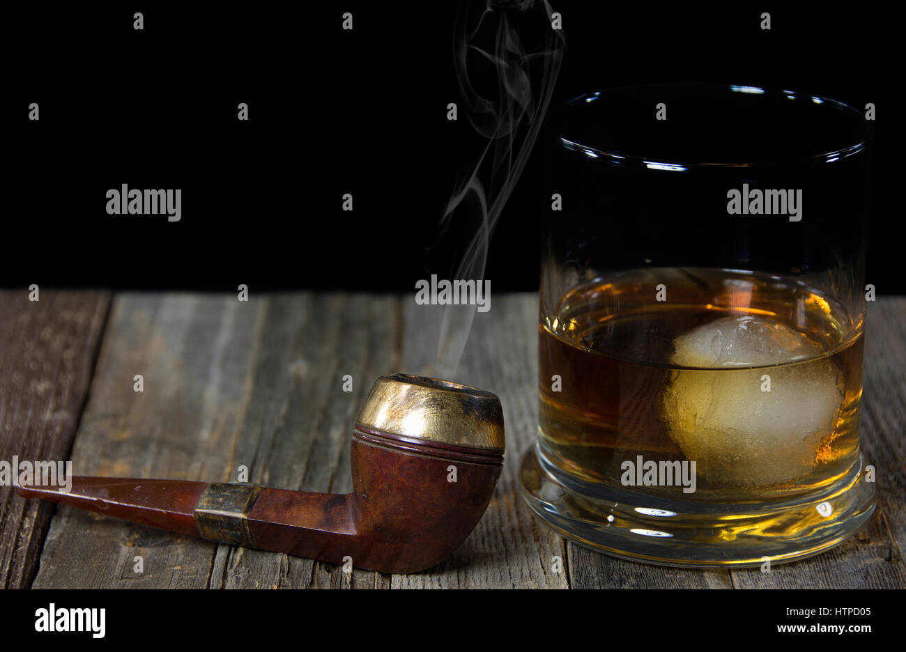 smoking-pipe-with-whiskey-drink-on-rustic-wood-HTPD05.jpg