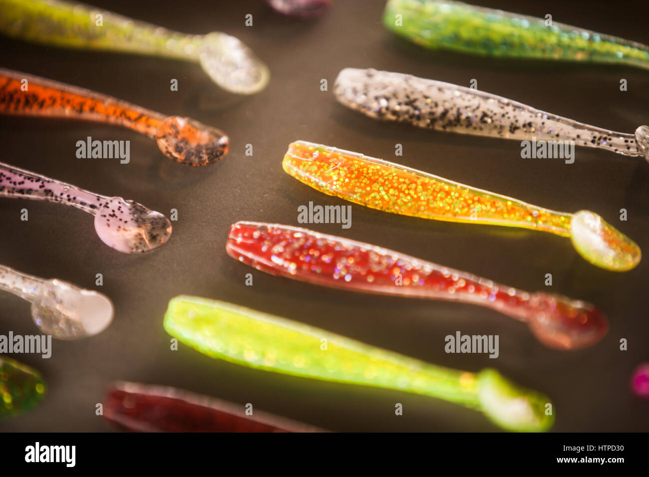 three red, orange, and yellow single hook fishing lures