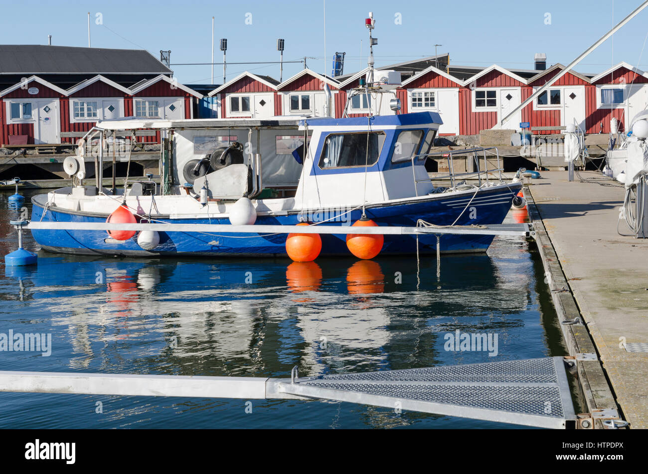 one little fishing boat in the harbour wait to go out and fish Stock Photo