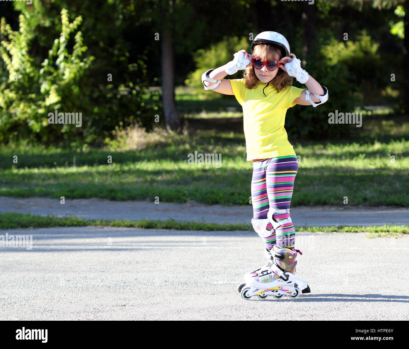 little girl with roller skates and sunglasses Stock Photo Alamy