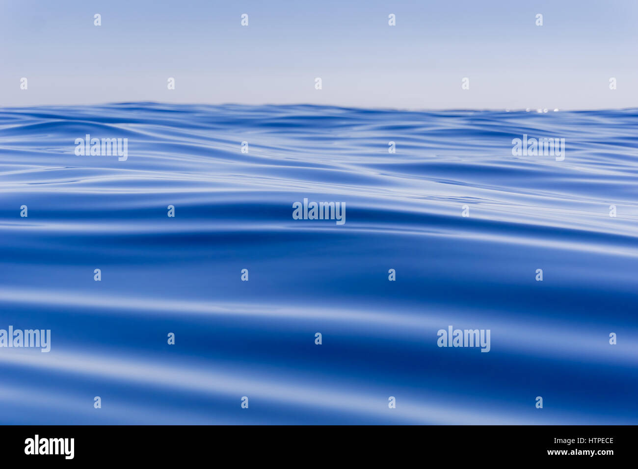 Abstract background deep blue ocean motion defocused to horizon ...