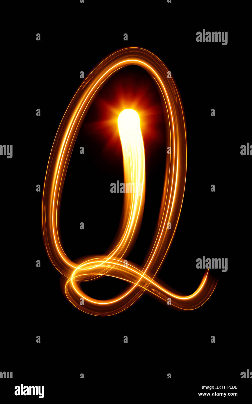 Q - Created by light alphabet over black background Stock Photo