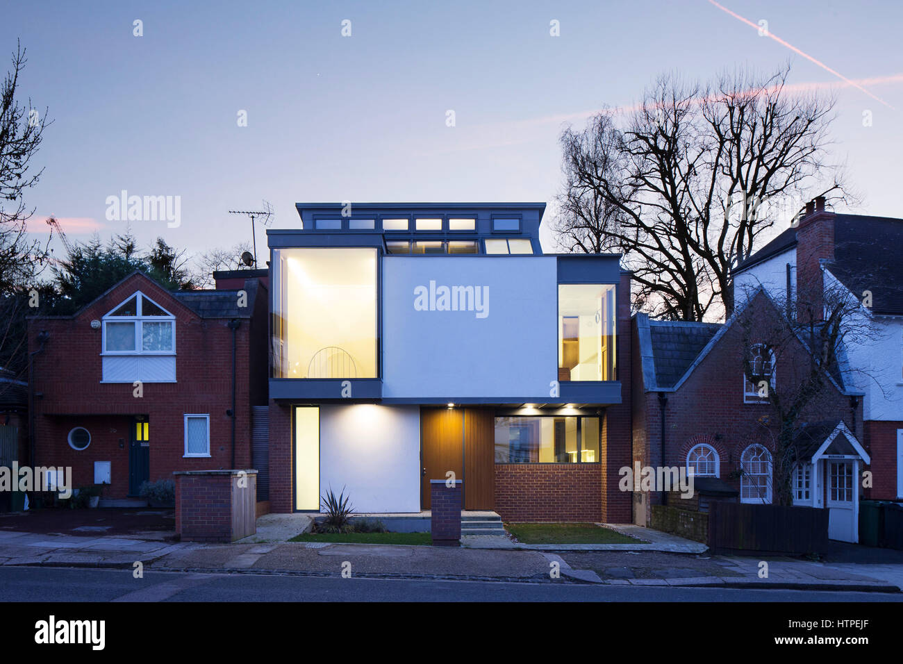 Exterior view at dusk of front of house. Private House, London, United Kingdom. Architect: Panter Hudspith Architects, 2017. Stock Photo
