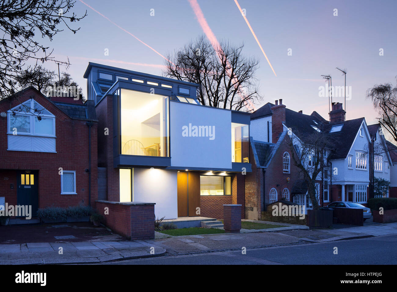 Exterior view at dusk of front of house. Private House, London, United Kingdom. Architect: Panter Hudspith Architects, 2017. Stock Photo