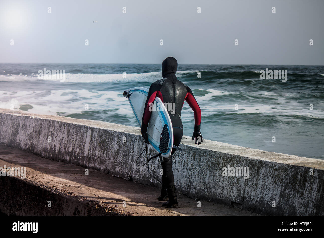 Surfer wearing wetsuit runs ocean hi-res stock photography and images ...