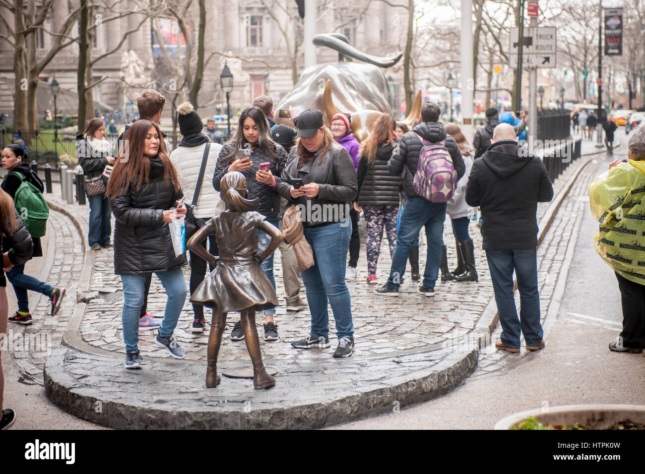 The bronze statue, 'The Fearless Girl' by the artist Kristen Visbal attracted attention at Bowling Green Park in New York on its first day, Tuesday, March 7, 2017. Installed just prior to International Women's Day, it is a campaign by State Street Global Advisors (SSGA) to educate the companies that have women in executive positions perform better and to call on the 3500 companies that collectively have more than $30 trillion in market capitalization to increase the amount of women on their boards. SSGA has the SPDR®SSGA Gender Diversity Index ETF trading under the moniker 'SHE'. (© Richard B. Stock Photo