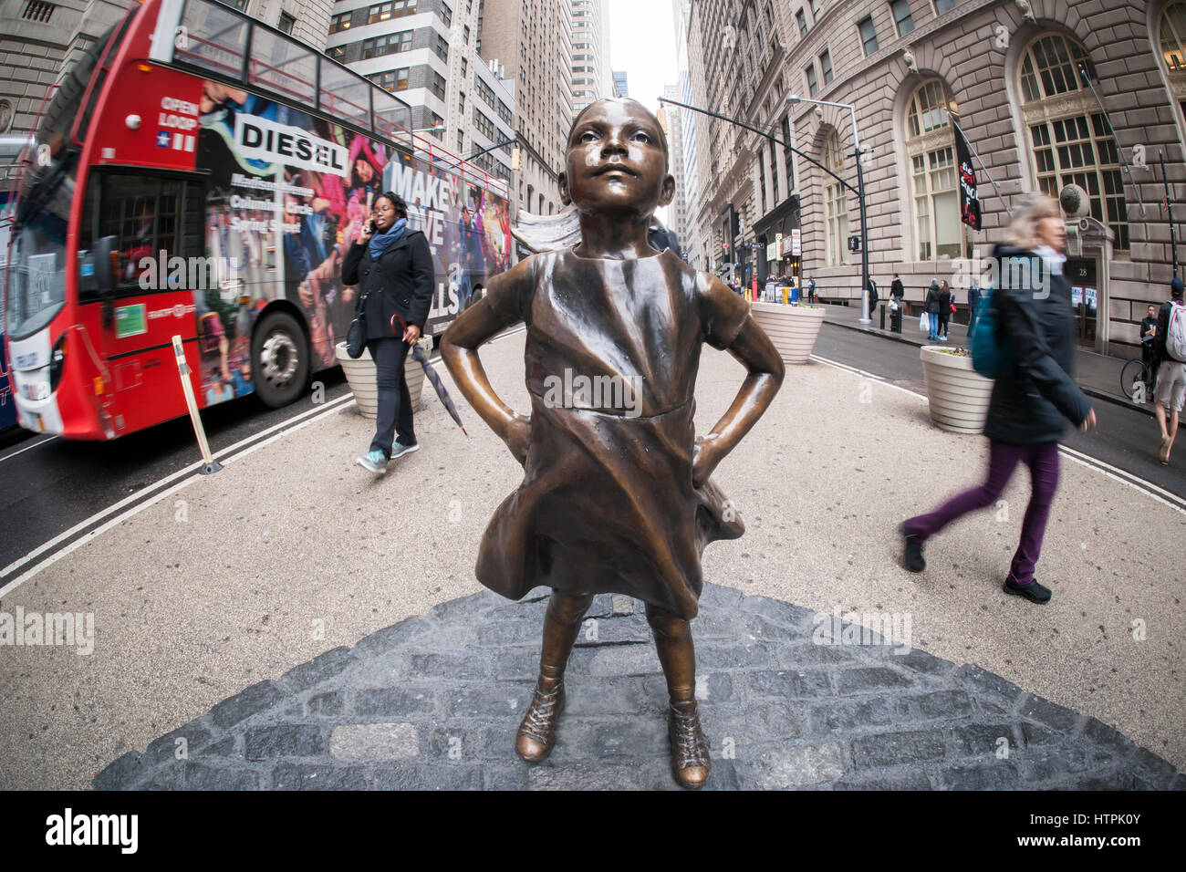 The bronze statue, 'The Fearless Girl' by the artist Kristen Visbal attracted attention at Bowling Green Park in New York on its first day, Tuesday, March 7, 2017. Installed just prior to International Women's Day, it is a campaign by State Street Global Advisors (SSGA) to educate the companies that have women in executive positions perform better and to call on the 3500 companies that collectively have more than $30 trillion in market capitalization to increase the amount of women on their boards. SSGA has the SPDR®SSGA Gender Diversity Index ETF trading under the moniker 'SHE'. (© Richard B. Stock Photo