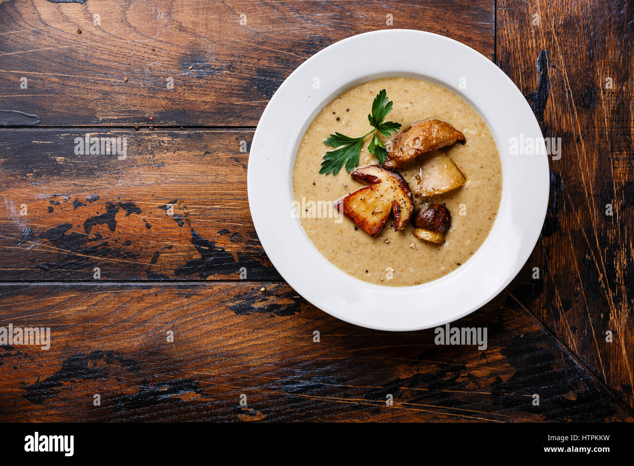 Cream soup with porcini mushroom on wooden table copy space Stock Photo