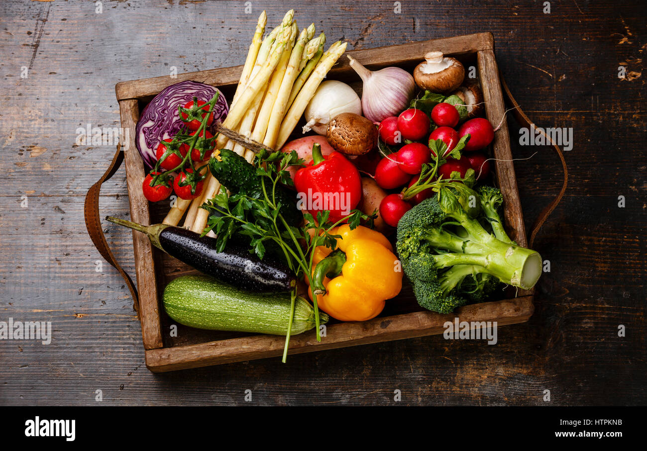 Fresh vegetables in wooden box on wooden background Stock Photo