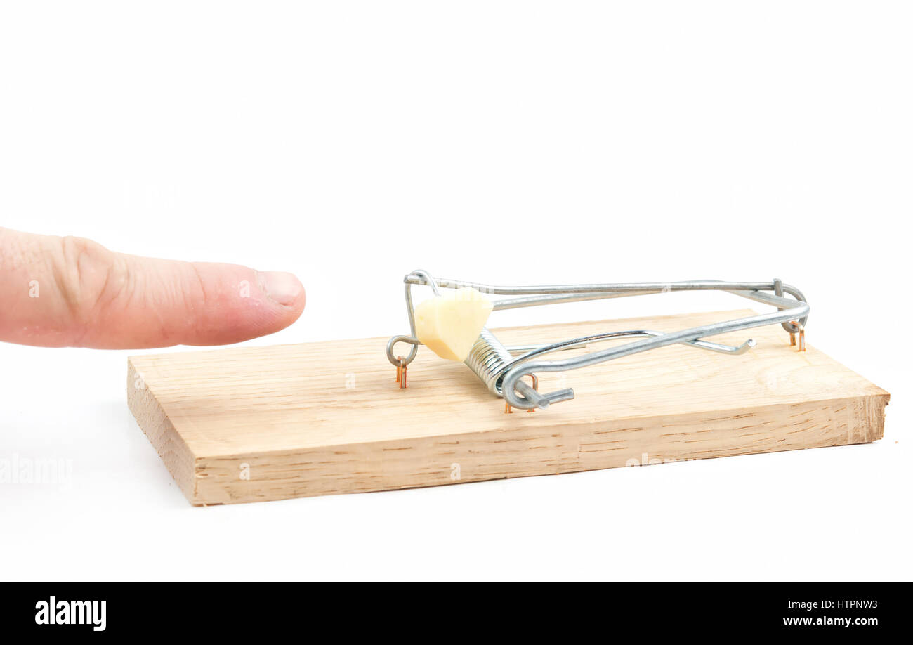 Male finger caught by mouse trap on white background Stock Photo