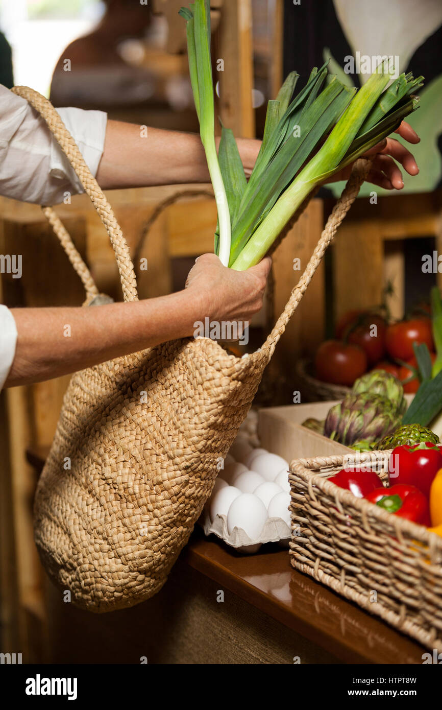 Woman buying leafy vegetable at organic section in supermarket Stock Photo