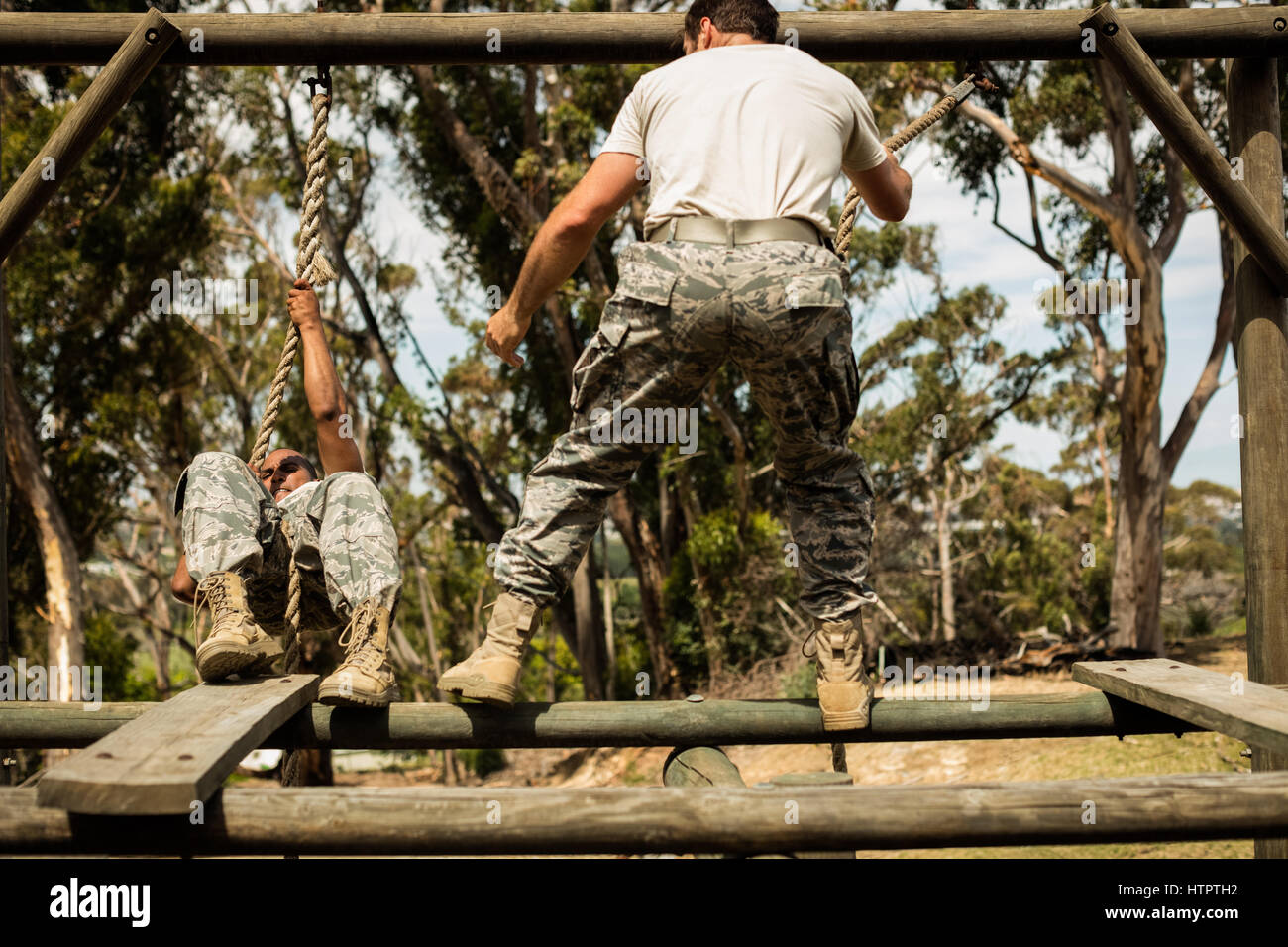 Military soldiers training rope climbing at boot camp Stock Photo