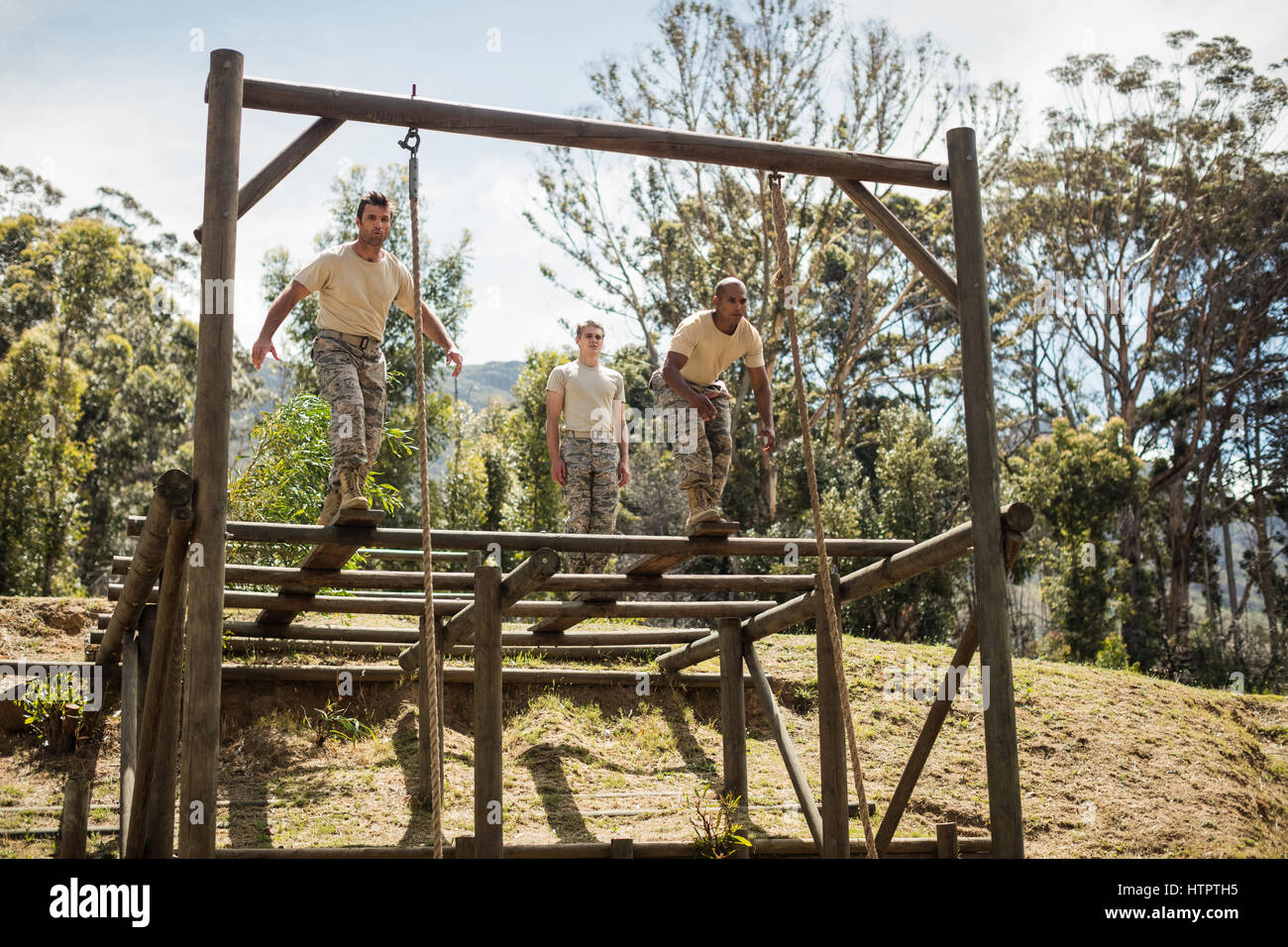 Military soldiers training rope climbing at boot camp Stock Photo - Alamy