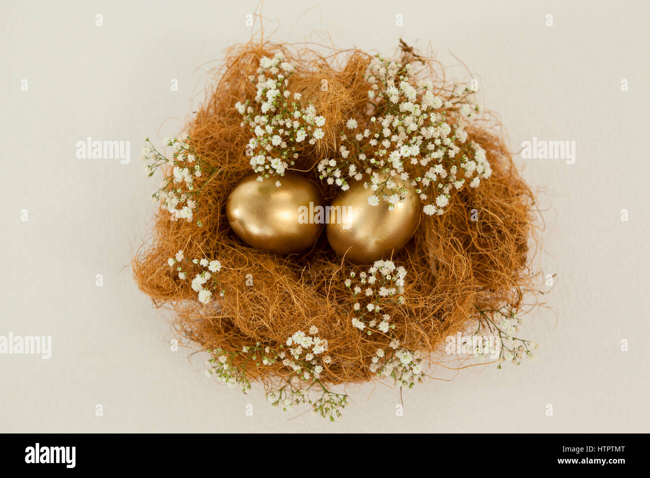 Golden easter eggs in nest against white background Stock Photo - Alamy